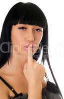 Young woman with a finger at lips