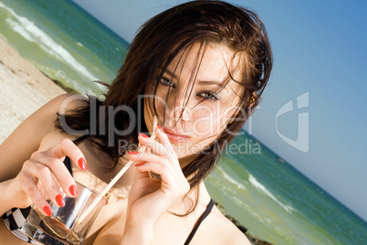 Portrait of the beautiful young woman on a beach
