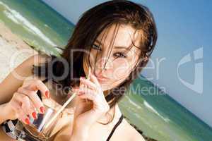 Portrait of the beautiful young woman on a beach
