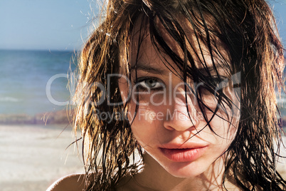 Portrait of the expressive young woman on a beach
