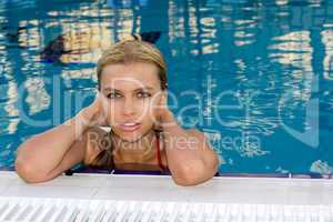Portrait of the wet sexy young blonde in pool
