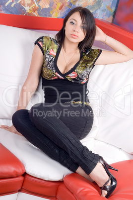 Lovely young woman sitting on a sofa