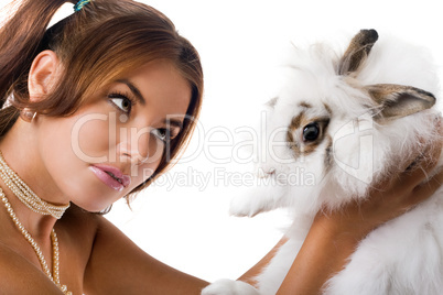 Young woman playing with little rabbit
