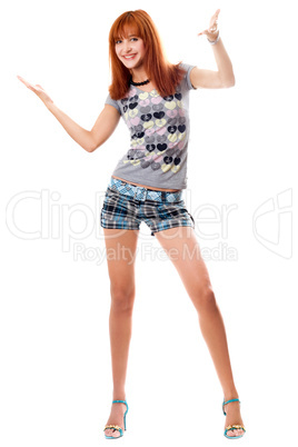 Happy red-haired girl in a t-shirt and shorts