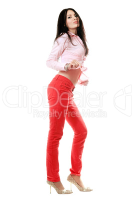 Playful young brunette in red jeans