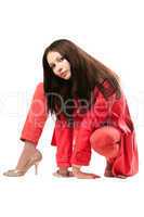 Playful attractive young woman in red suit. Isolated