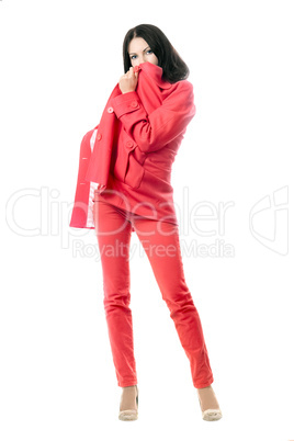 Playful brunette in red suit. Isolated