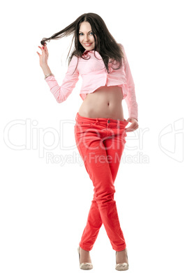 Smiling sexy young brunette in red jeans