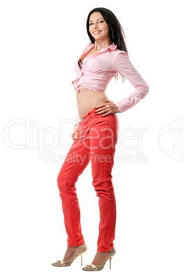 Smiling beautiful young brunette in red jeans