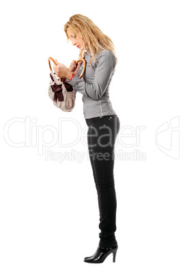 Young blonde looks in her handbag