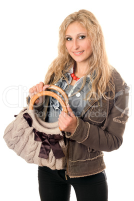 Portrait of smiling young blonde with a handbag