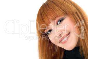 Portrait of the attractive smiling redheaded woman