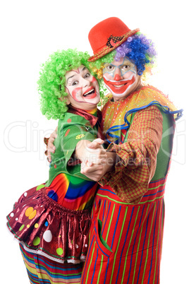 A couple of smiling clowns dancing