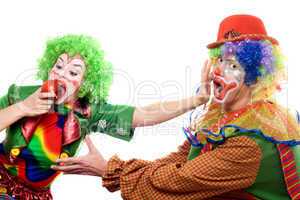 Clowns are fighting for an apple