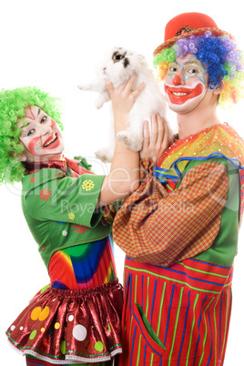 Two playful clown with a white rabbit