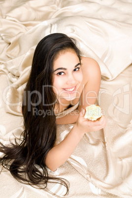 Smiling young brunette with apple