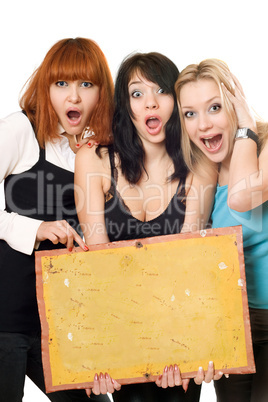 Excited women holding a board