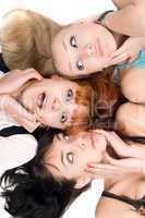 Three amazed women touching their cheeks