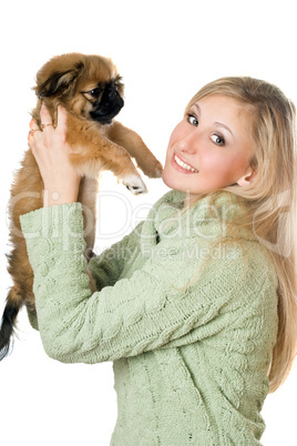 Young woman playing with a pekinese