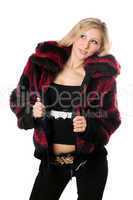 Young sexy blond woman in a fur jacket