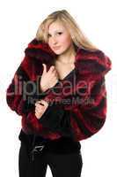 Sexy blond woman in a fur jacket