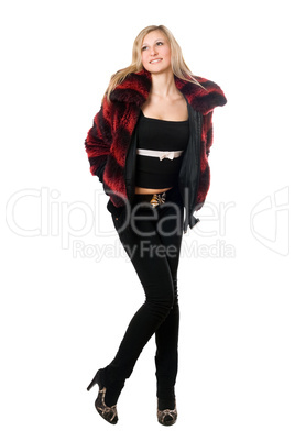 Happy young blond woman in a fur jacket