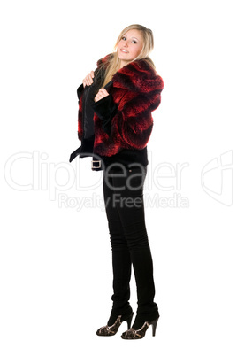 Smiling young blond woman in a fur jacket