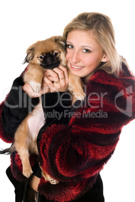 Young woman holding a pekinese