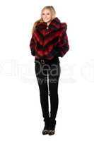 Pretty woman posing in fur jacket. Isolated