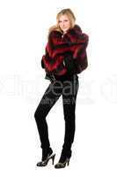 Pretty blonde posing in fur jacket. Isolated
