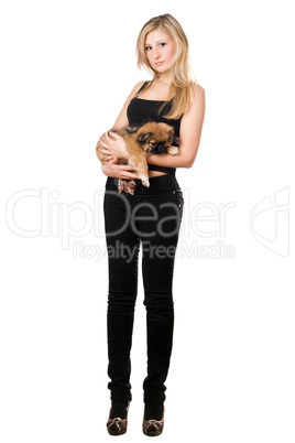 Pretty woman in black pants holding puppy