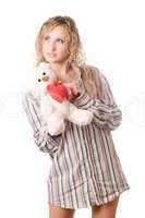 Thoughtful blonde holding teddy bear