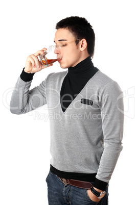 Young man drinking whiskey