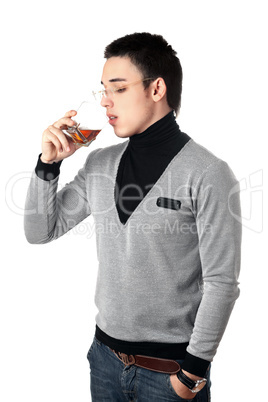 Young man drinking whiskey from a glass