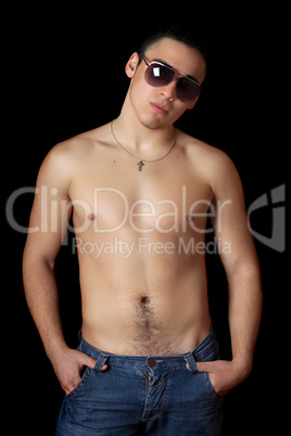 Handsome young man in sunglasses. Isolated on black