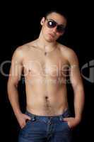 Handsome young man in sunglasses. Isolated on black