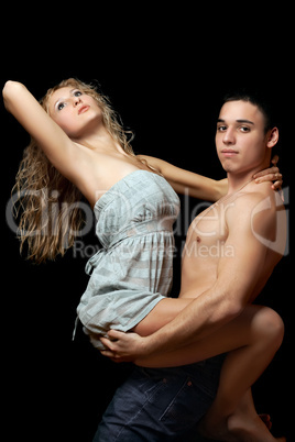 Young man holds a beautiful blonde