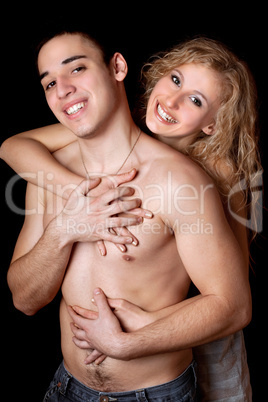 Portrait of happy young couple. Isolated on black