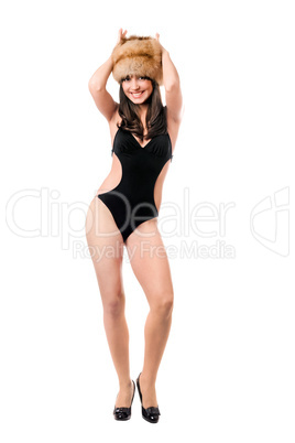 Smiling woman wearing swimsuit and fur-cap