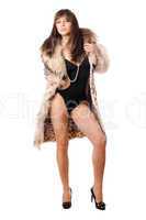 Sexy brunette wearing swimsuit and leopard coat