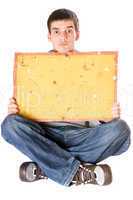 Surprised young man holding yellow board