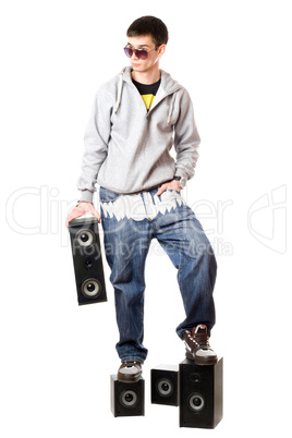 man in sunglasses standing on the speakers