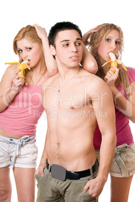 Young man and two pretty women with bananas