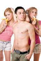 Young man and two pretty women with bananas