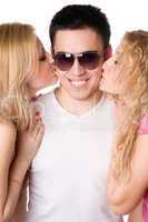 Two beautiful blonde kissing young man