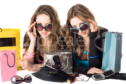 Two smiling beautiful girlfriends in sunglasses