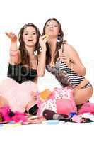 Two cheerful girls blow bubbles. Isolated