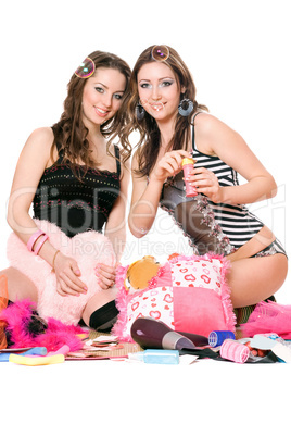 Two pretty girls blow bubbles. Isolated