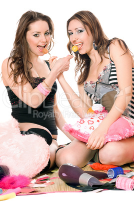 Two smiling girls with candy. Isolated