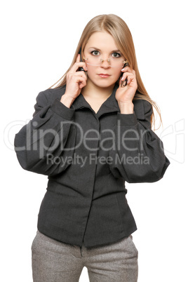 Portrait of serious young blonde in a gray business suit